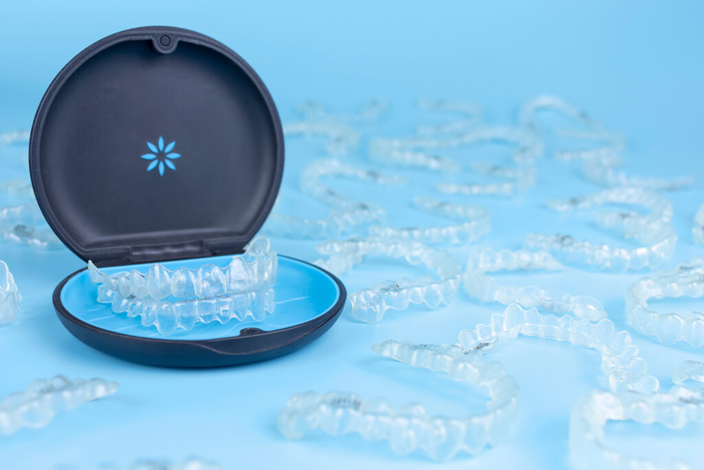clear aligners in invisalign container surrounded by clear aligners