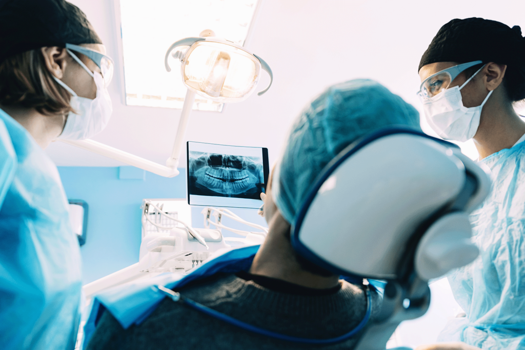 dentists showing dental x-ray to patient in dental chair