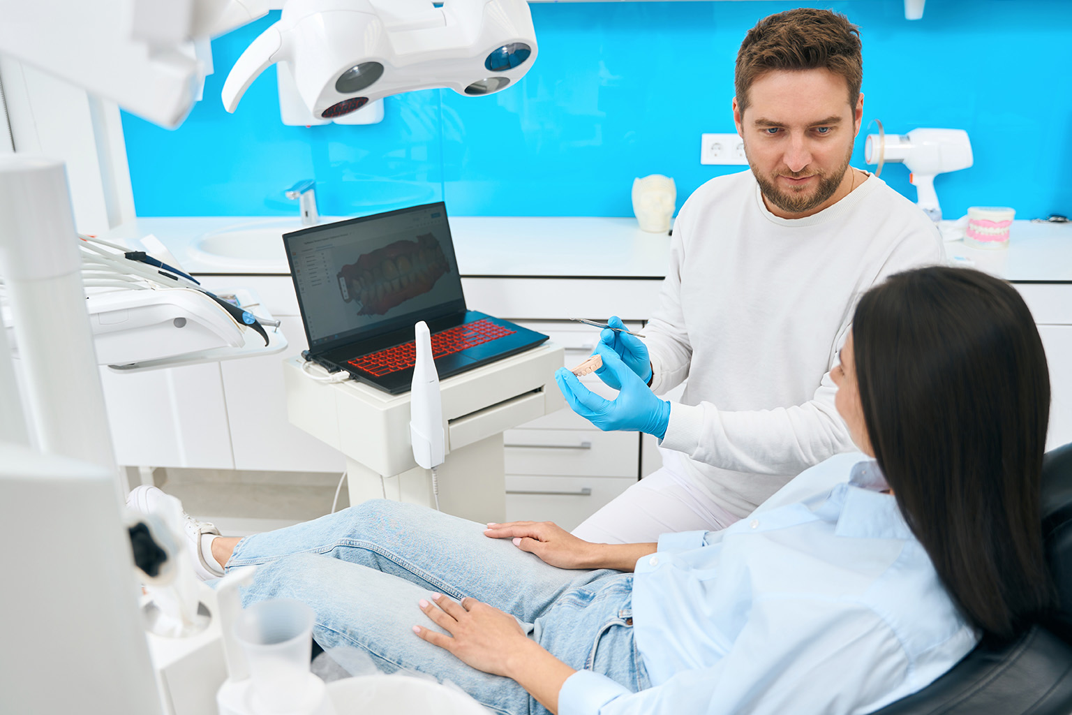 dentist talking to dental patient in dental chair