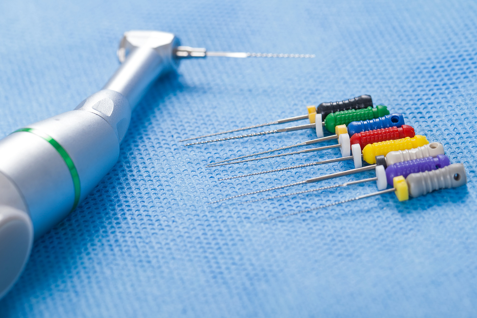 dental tools for performing a root canal on blue cloth