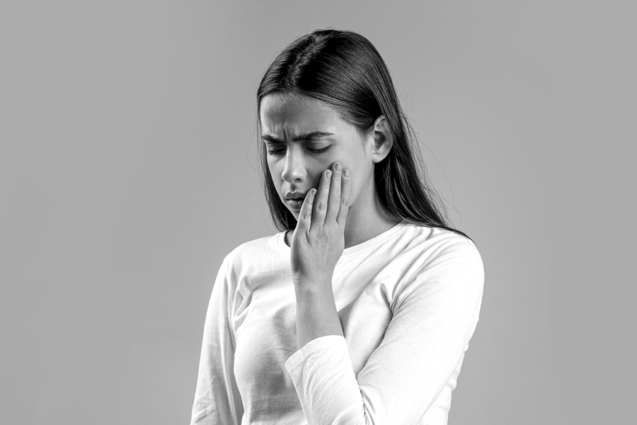woman holding her cheek