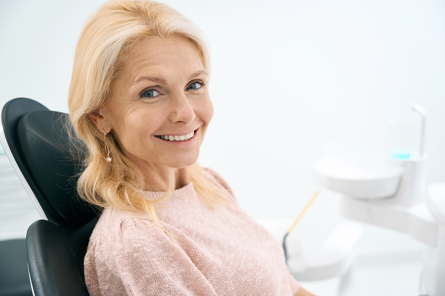 smiling blonde woman in dental chair