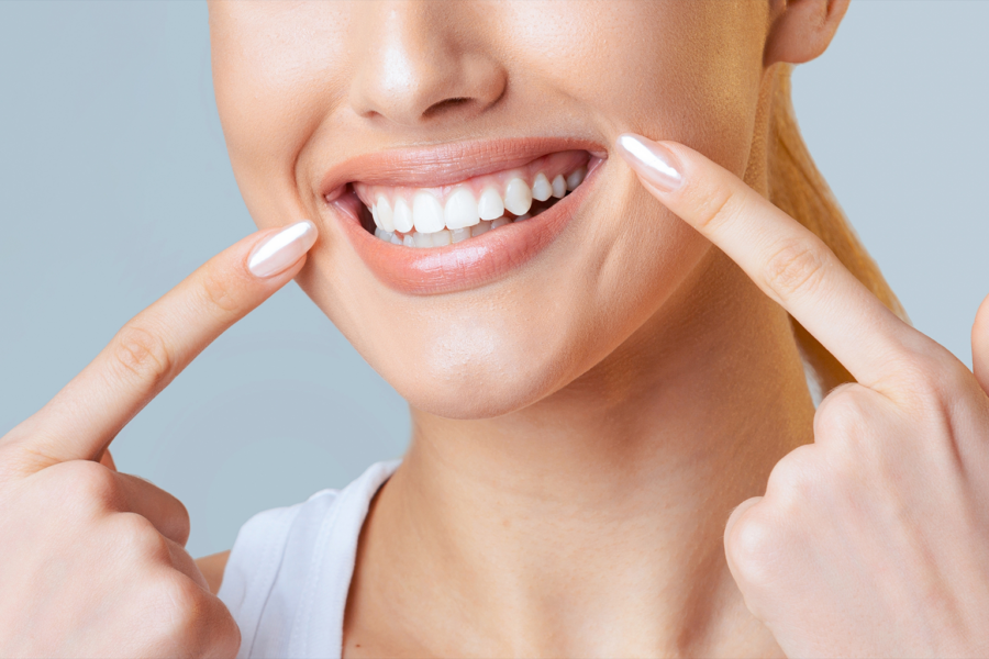 woman pointing at her smile