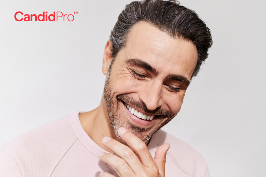 smiling man with his hand on his chin