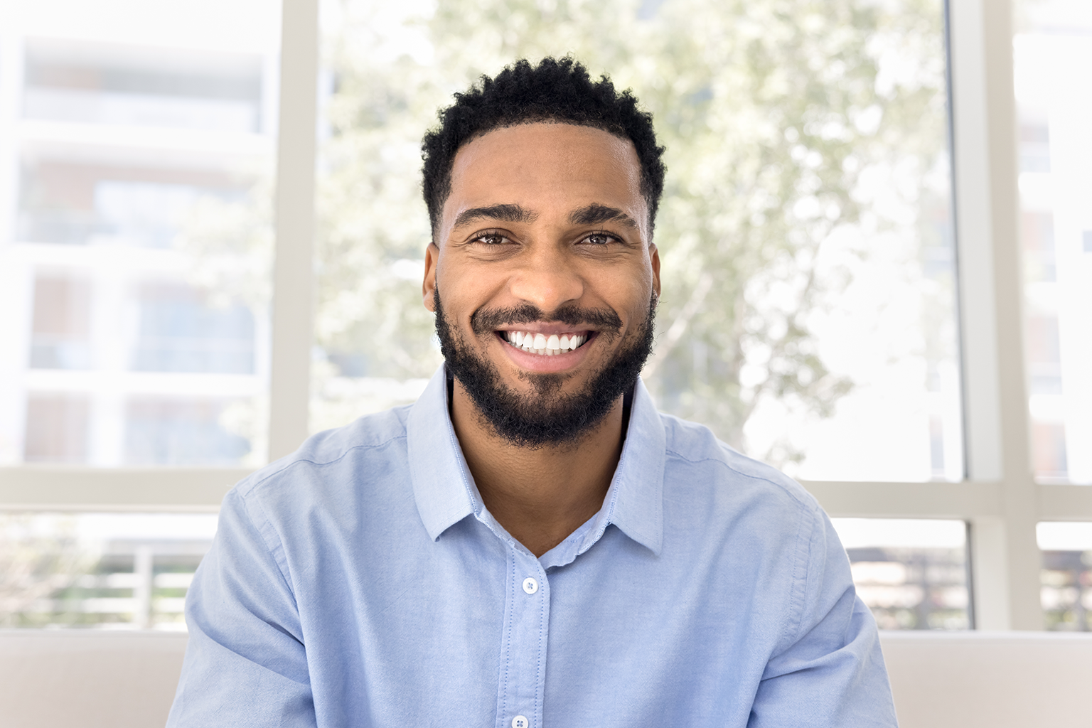 smiling man in blue shirt