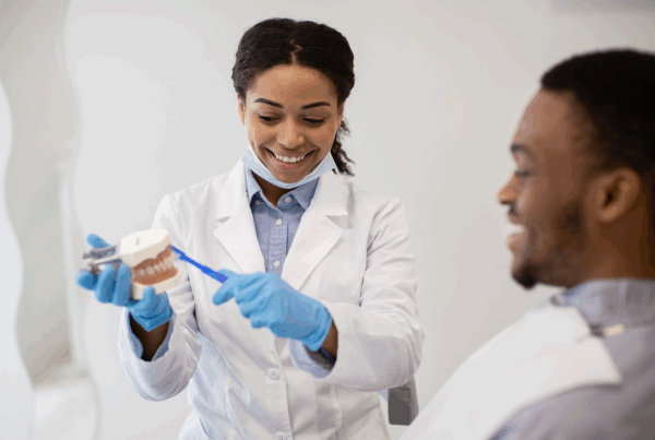 dentist showing dental model to patient